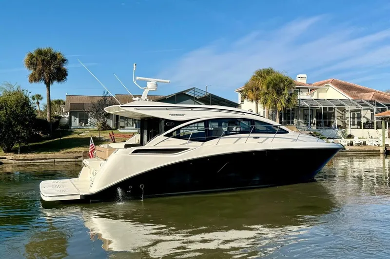 Lady Laura Yacht Photos Pics 2016 Sea Ray Sundancer 400 yacht docked by waterfront homes, clear blue sky.