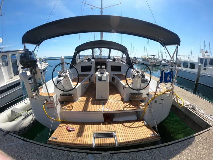 Flyin Yacht Photos Pics 2020 Jeanneau Sun Odyssey 410 sailboat docked, featuring dual steering wheels and spacious deck.