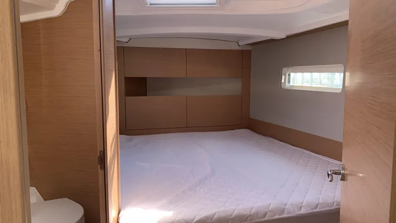 Flyin Yacht Photos Pics Cozy cabin interior of 2020 Jeanneau Sun Odyssey 410 sailboat with modern wood finish.