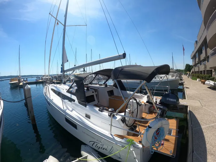 Flyin Yacht Photos Pics 2020 Jeanneau Sun Odyssey 410 sailboat docked at marina under clear blue sky.