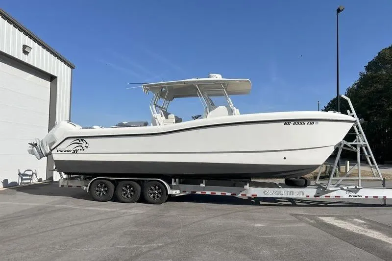  Yacht Photos Pics 2022 Prowler 31 boat on trailer outside a warehouse.