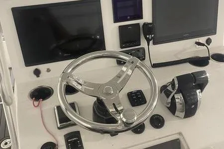  Yacht Photos Pics Control panel of 2022 Prowler 31 boat with steering wheel and navigation equipment.