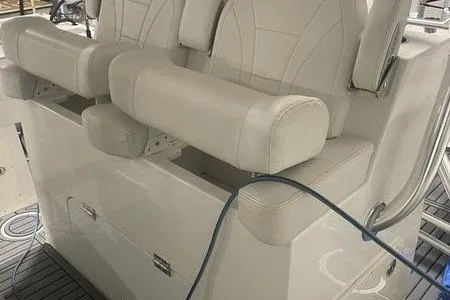  Yacht Photos Pics 2022 Prowler 31 boat interior with white cushioned seating and armrests.