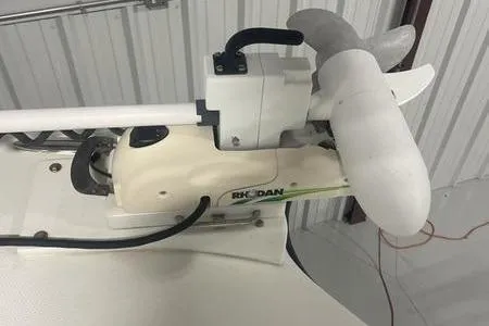  Yacht Photos Pics 2022 Prowler 31 boat equipment with mounted trolling motor in a storage area.