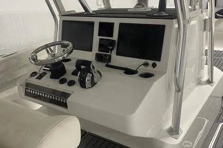  Yacht Photos Pics 2022 Prowler 31 boat dashboard with steering wheel and electronic displays.