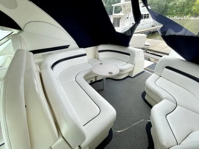 "jimi Thing Iv" Yacht Photos Pics Luxurious 2007 Sea Ray 38 Sundancer yacht interior with white seating and table.