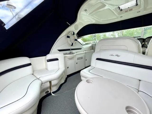 "jimi Thing Iv" Yacht Photos Pics Luxurious interior of 2007 Sea Ray 38 Sundancer yacht with white seating and table.