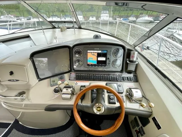 "jimi Thing Iv" Yacht Photos Pics 2007 Sea Ray 38 Sundancer helm with navigation controls and wooden steering wheel.