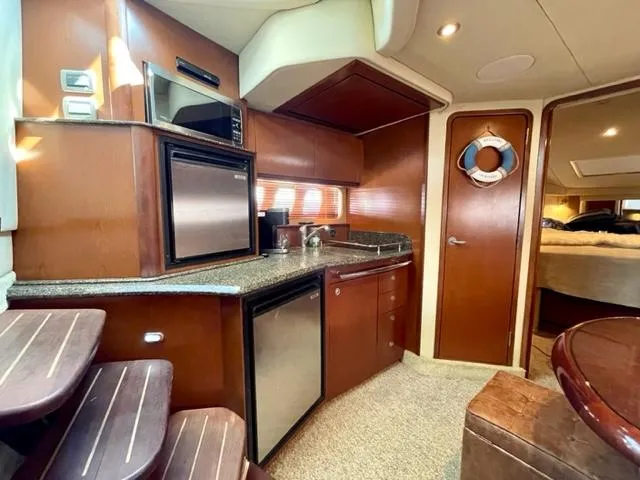 "jimi Thing Iv" Yacht Photos Pics Interior of 2007 Sea Ray 38 Sundancer yacht with kitchen and cozy cabin.