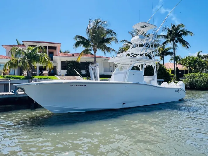  Yacht Photos Pics 2015 Billfish 39 Custom CC boat docked near a waterfront home.