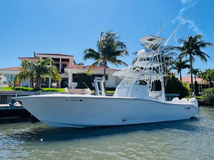  Yacht Photos Pics 2015 Billfish 39 Custom CC boat docked near a waterfront home.