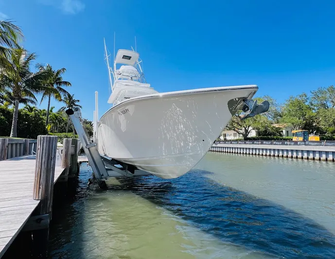  Yacht Photos Pics 2015 Billfish 39 Custom CC boat docked on a lift in a sunny marina.