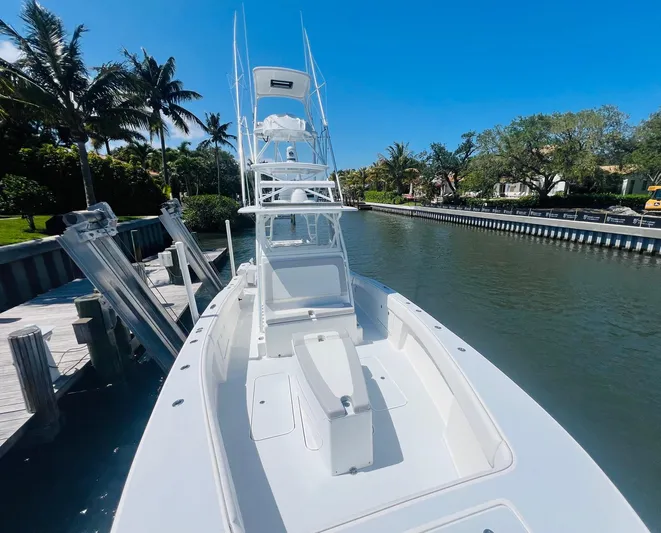  Yacht Photos Pics 2015 Billfish 39 Custom CC boat docked by a canal on a sunny day.