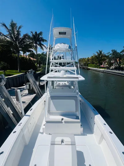  Yacht Photos Pics 2015 Billfish 39 Custom CC boat docked by a canal on a sunny day.