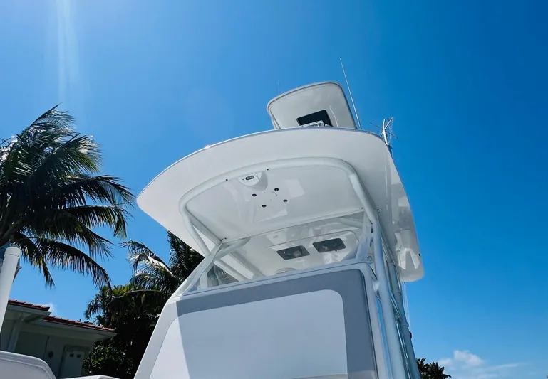  Yacht Photos Pics 2015 Billfish 39 Custom CC boat under clear blue sky with palm trees.