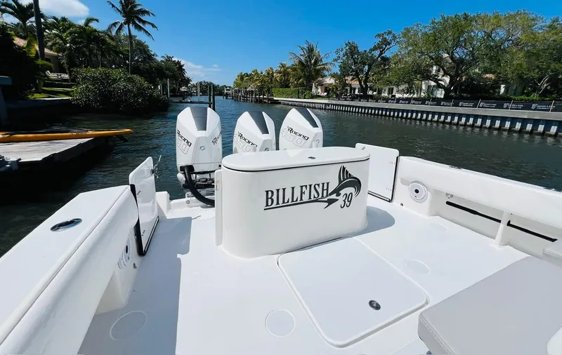  Yacht Photos Pics 2015 Billfish 39 Custom CC boat with triple outboard engines docked in a scenic canal.