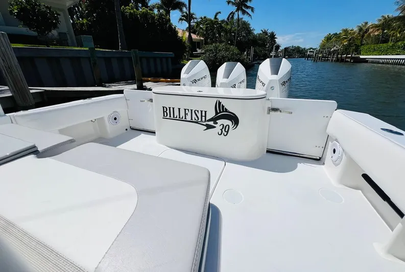  Yacht Photos Pics Billfish 39 Custom CC 2015 boat interior with triple outboard engines, docked by a canal.