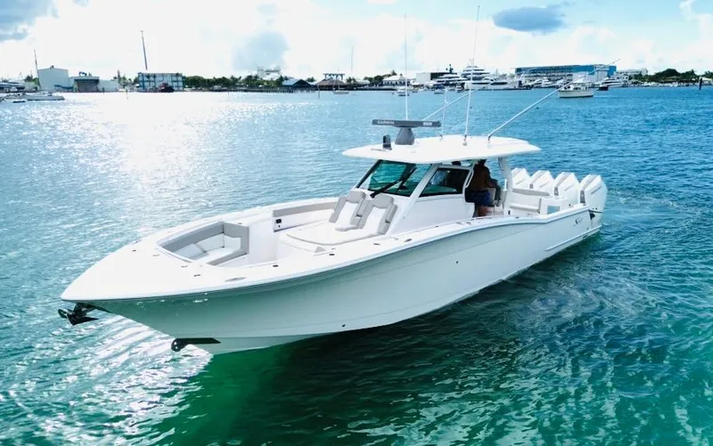  Yacht Photos Pics 2024 Scout 400 LXF luxury boat cruising on clear blue water.