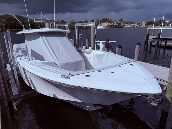  Yacht Photos Pics 2024 Scout 400 LXF boat docked under cloudy skies.
