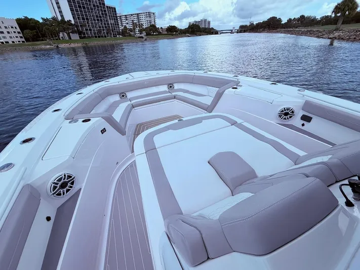  Yacht Photos Pics 2024 Scout 400 LXF boat interior with luxurious seating on a calm waterway.