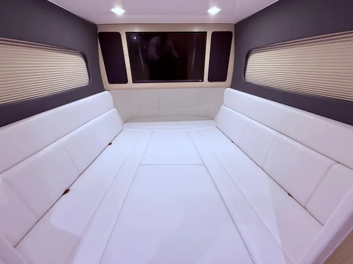  Yacht Photos Pics Luxurious interior cabin of 2024 Scout 400 LXF with white seating and modern design.