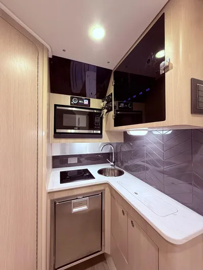  Yacht Photos Pics 2024 Scout 400 LXF yacht kitchen with modern appliances and sleek design.