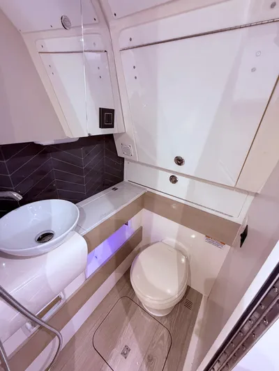  Yacht Photos Pics 2024 Scout 400 LXF boat bathroom with modern sink and toilet.