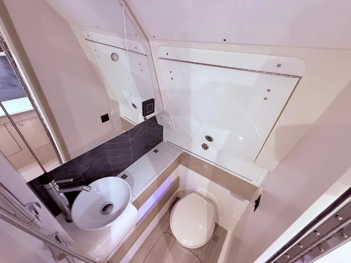  Yacht Photos Pics Luxurious bathroom interior of 2024 Scout 400 LXF boat, featuring modern sink and toilet.