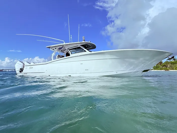  Yacht Photos Pics 2024 Scout 400 LXF boat on clear blue water under a bright sky.