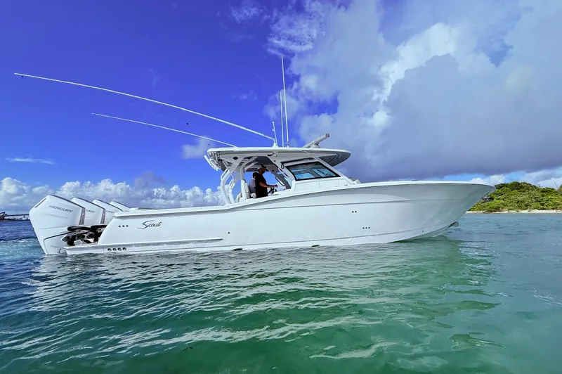  Yacht Photos Pics 2024 Scout 400 LXF boat on clear water under a blue sky.