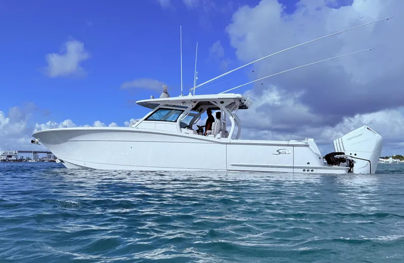  Yacht Photos Pics 2024 Scout 400 LXF boat on water under blue sky.