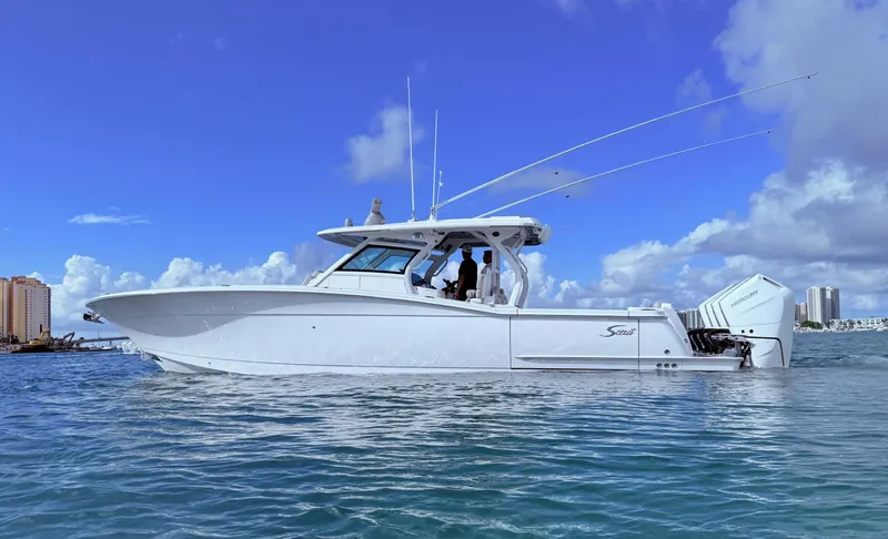  Yacht Photos Pics 2024 Scout 400 LXF boat on water under clear blue sky.