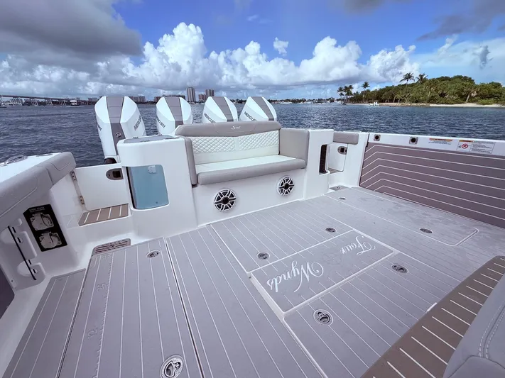  Yacht Photos Pics 2024 Scout 400 LXF boat deck with seating, ocean view, and four outboard engines.