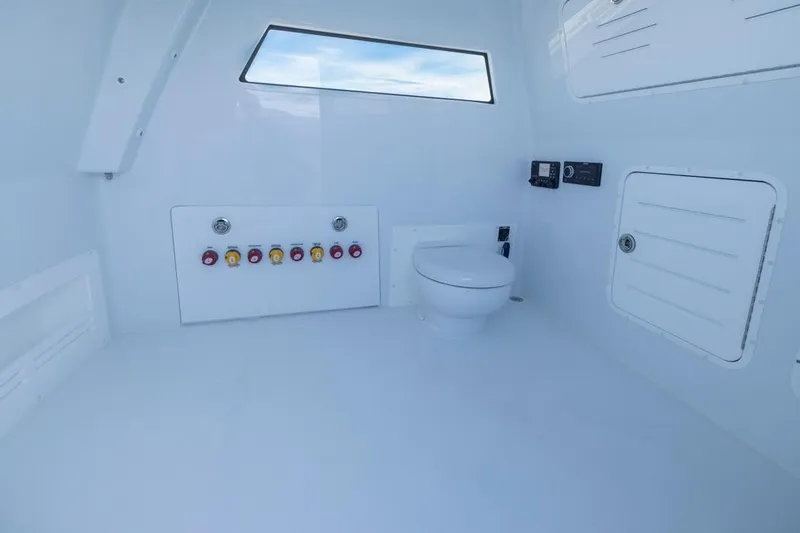  Yacht Photos Pics Interior of 2026 Invincible 46 Catamaran featuring a modern marine toilet setup.