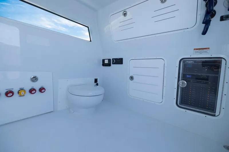  Yacht Photos Pics Interior of 2026 Invincible 46 Catamaran featuring modern marine toilet and control panel.