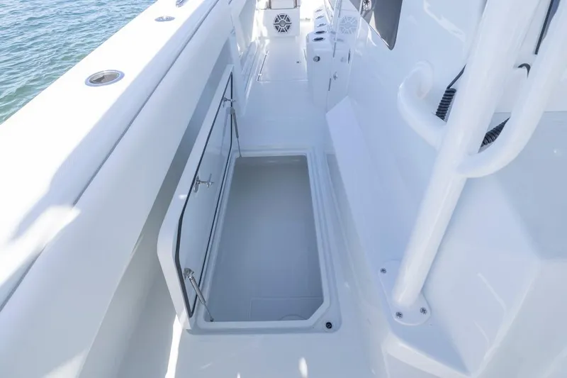  Yacht Photos Pics 2026 Invincible 46 Catamaran deck with open storage compartment, sleek white design.