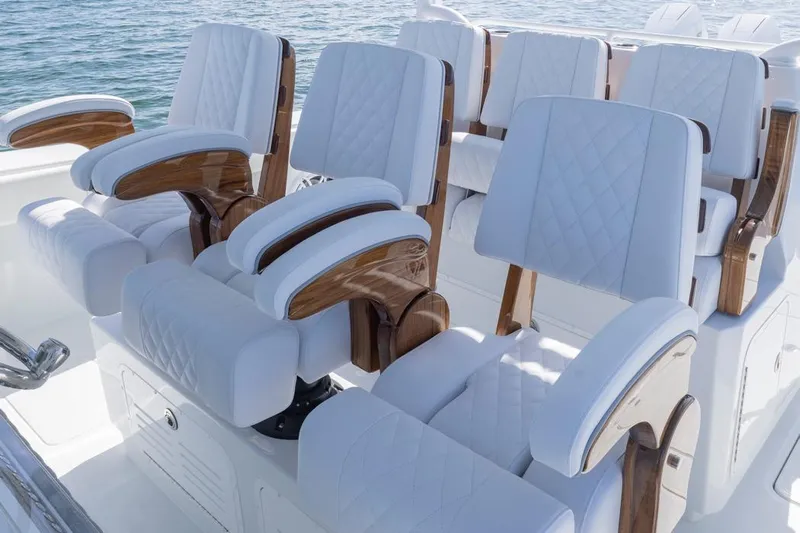  Yacht Photos Pics Luxurious seating on 2026 Invincible 46 Catamaran, featuring elegant white upholstery and wooden accents.
