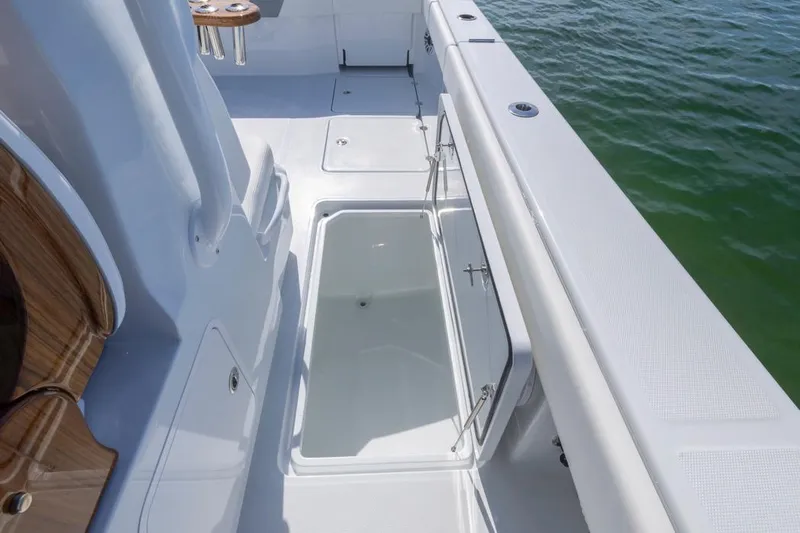  Yacht Photos Pics 2026 Invincible 46 Catamaran deck with storage compartment, sleek design, and ocean view.
