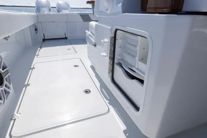  Yacht Photos Pics 2026 Invincible 46 Catamaran deck with storage compartments and sleek design.