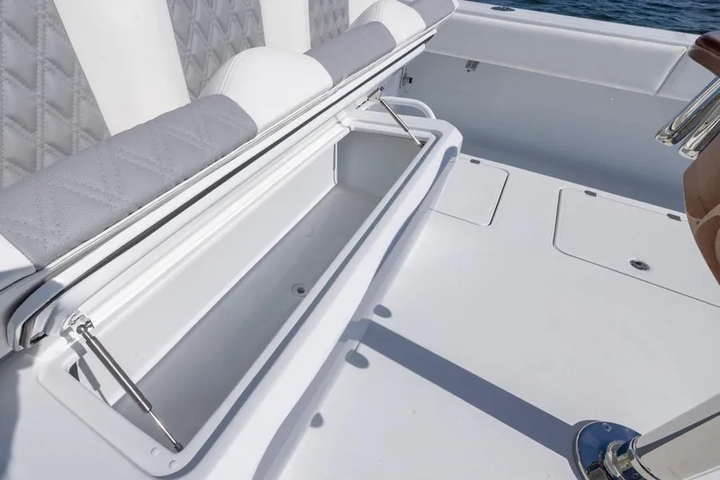  Yacht Photos Pics Open storage compartment on 2026 Invincible 46 Catamaran, featuring cushioned seating and sleek design.