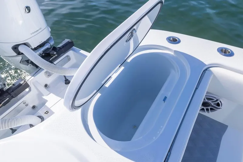  Yacht Photos Pics Open storage compartment on 2026 Invincible 46 Catamaran, with visible engine and water backdrop.