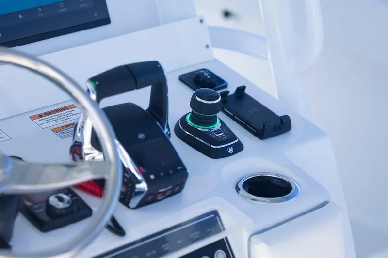  Yacht Photos Pics Control panel of 2026 Invincible 46 Catamaran with steering wheel and throttle.