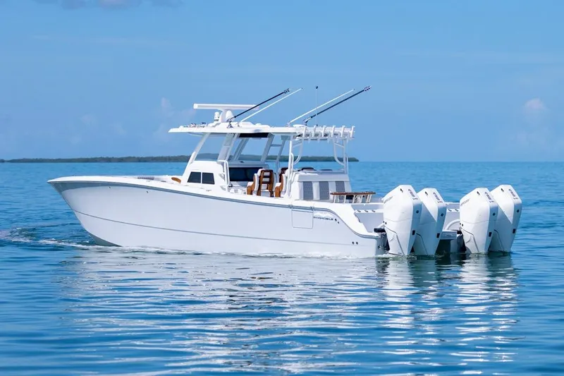  Yacht Photos Pics 2026 Invincible 46 Catamaran cruising on calm blue waters.