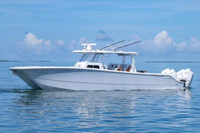  Yacht Photos Pics 2026 Invincible 46 Catamaran on calm ocean waters under a clear blue sky.
