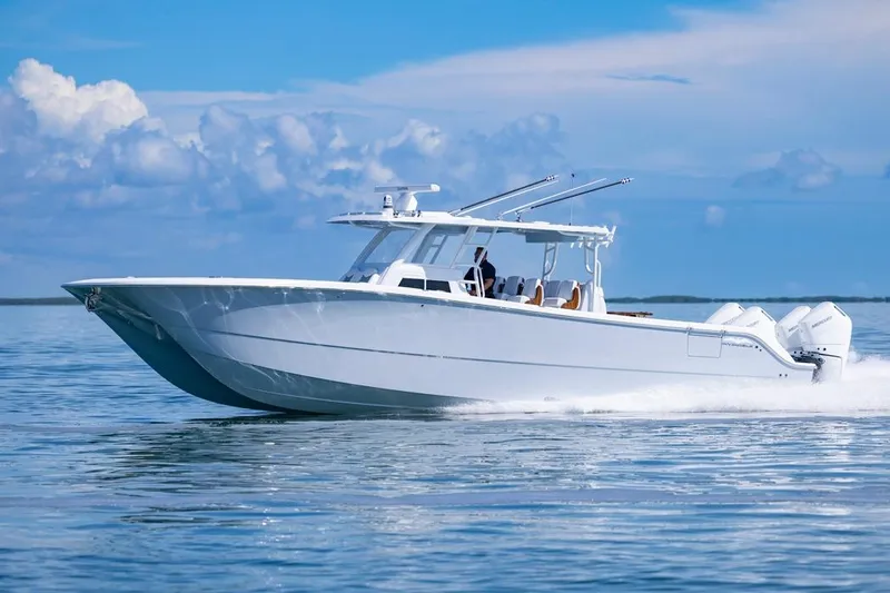  Yacht Photos Pics 2026 Invincible 46 Catamaran cruising on calm ocean waters under a clear blue sky.