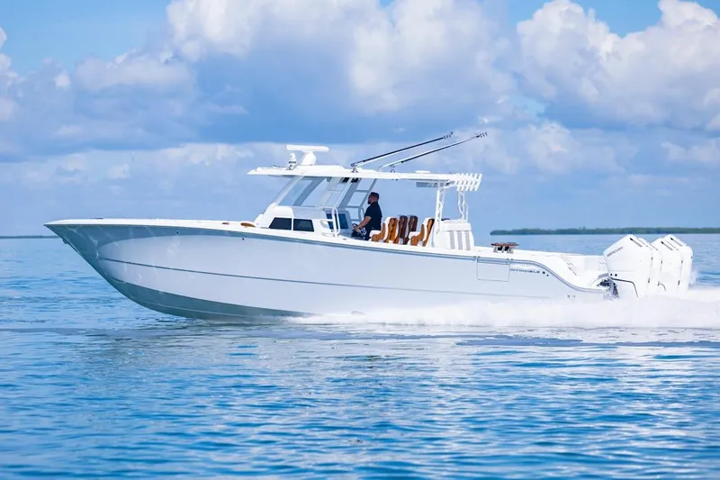  Yacht Photos Pics 2026 Invincible 46 Catamaran cruising on calm blue waters under a clear sky.