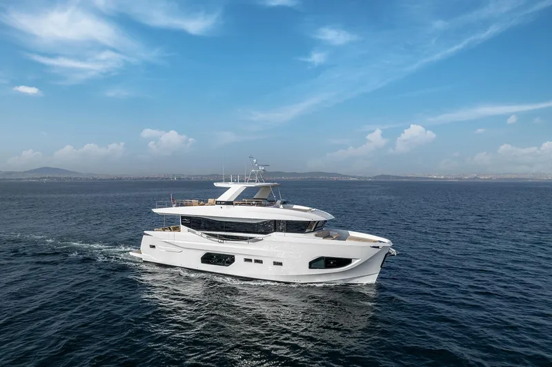 Numarine 22xp Yacht Photos Pics 2025 Numarine 22XP yacht cruising on open sea under clear blue sky.