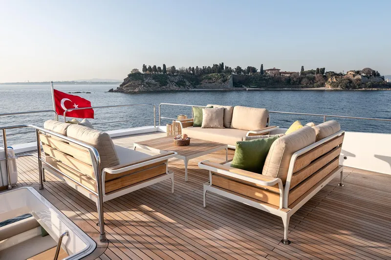 Numarine 22xp Yacht Photos Pics Luxurious 2025 Numarine 22xp yacht deck with seating, Turkish flag, and scenic coastal view.