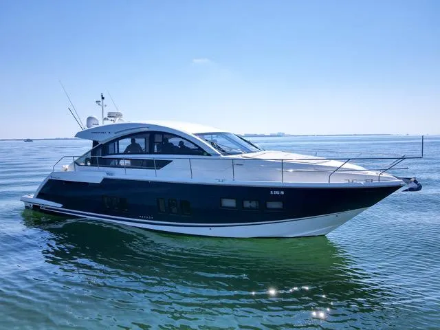  Yacht Photos Pics 2013 Fairline Targa 50 GT yacht cruising on calm waters under a clear blue sky.