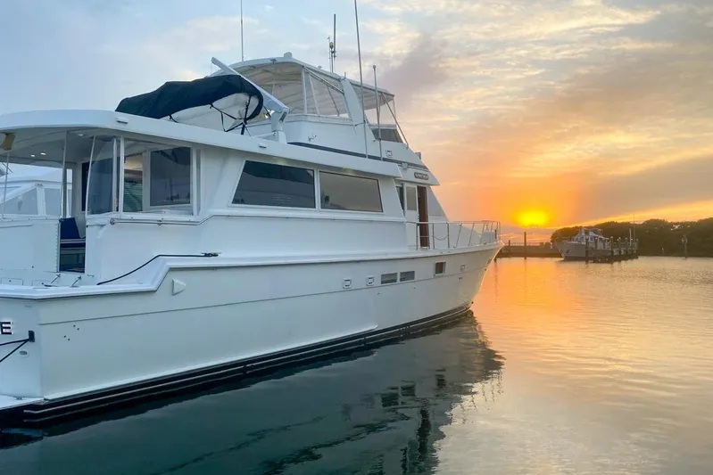 Sunset Grille Yacht Photos Pics 1990 Hatteras 62 Cockpit Motor Yacht at sunset on calm water.